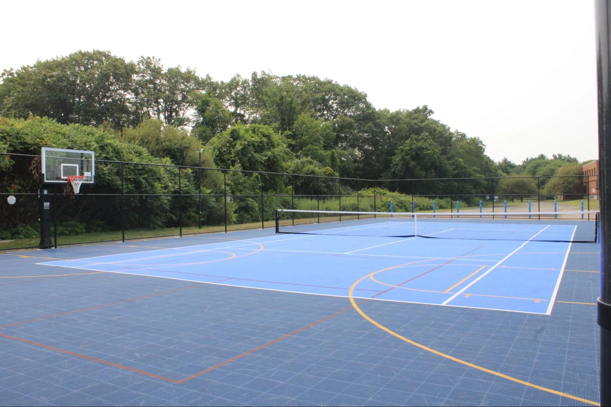Students' multi-sports court at SELA's Hingham campus on a bright day.